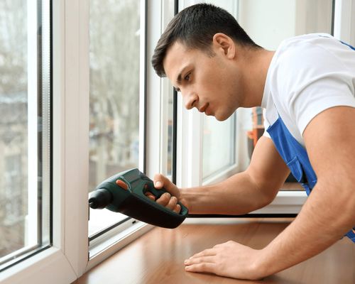 worker finalizing the installation of replacement window