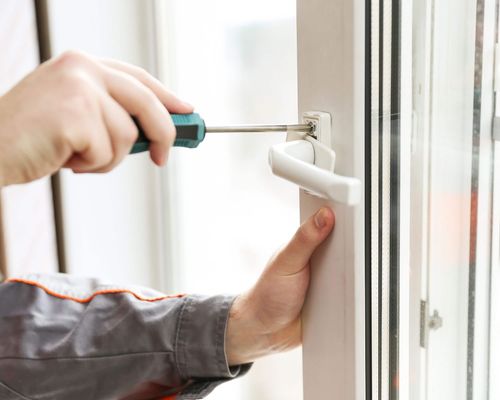worker installing handle of a replacement window